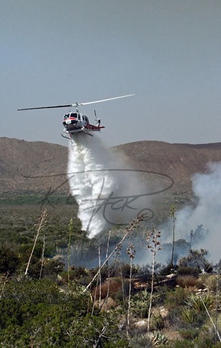Firefighting helicopter dropping water