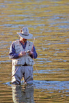 Fly Fisherman tying on new fly